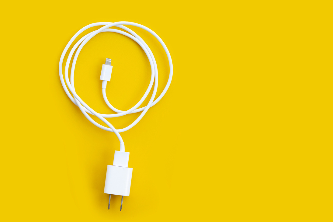Mobile phone charger on yellow background.